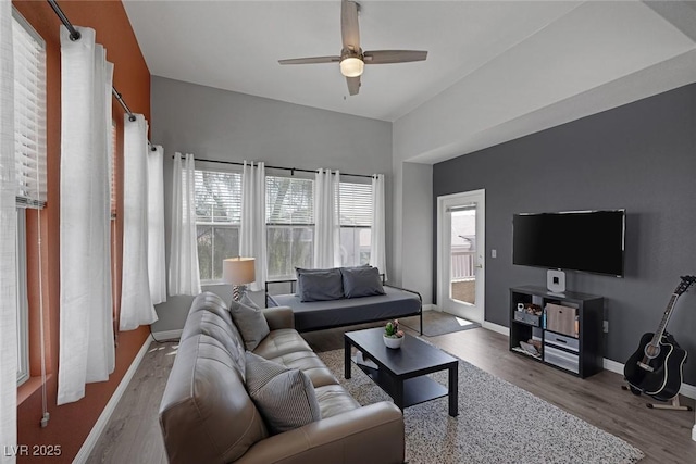 living room with baseboards, ceiling fan, and wood finished floors