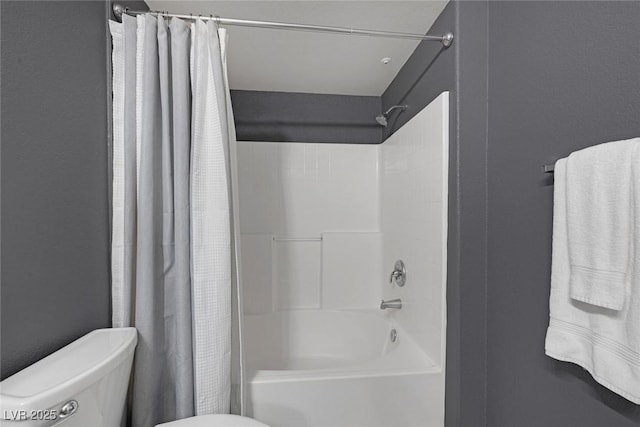 bathroom featuring toilet and shower / tub combo with curtain