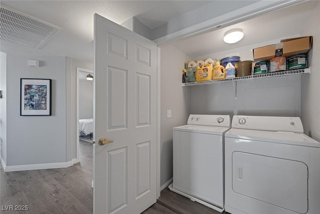 laundry area featuring laundry area, independent washer and dryer, visible vents, baseboards, and dark wood-type flooring