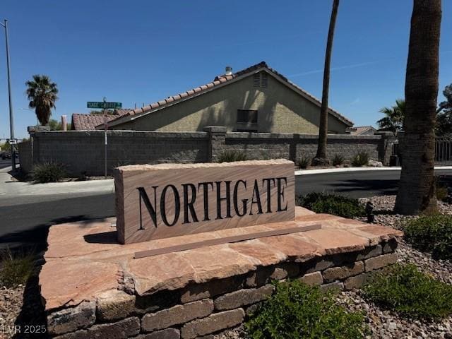 community sign featuring fence