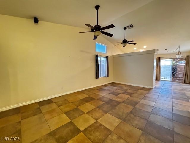 spare room featuring ceiling fan, baseboards, and lofted ceiling