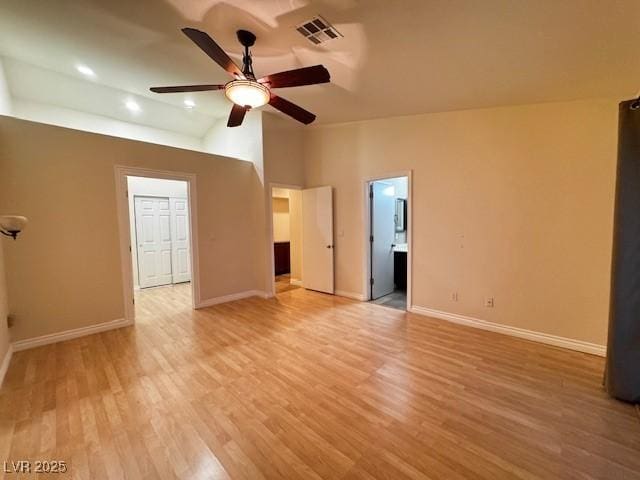 interior space featuring baseboards, lofted ceiling, and visible vents