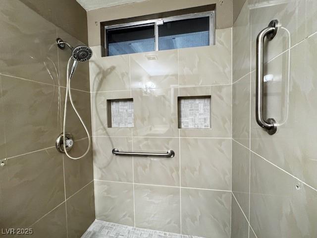 full bath featuring tiled shower
