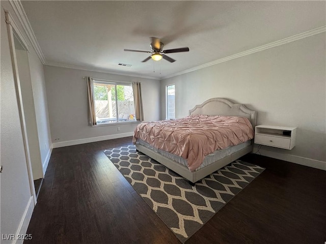 bedroom with wood finished floors, crown molding, and ceiling fan