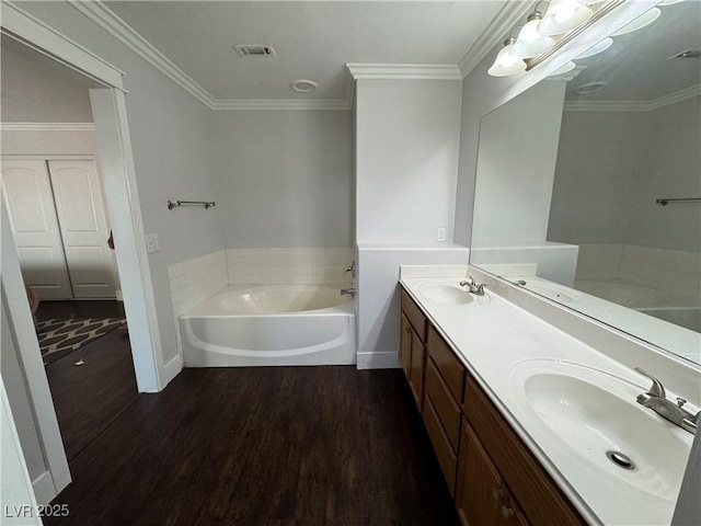 full bath with a bath, double vanity, wood finished floors, and ornamental molding