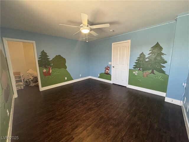 unfurnished room featuring baseboards, ceiling fan, and wood finished floors
