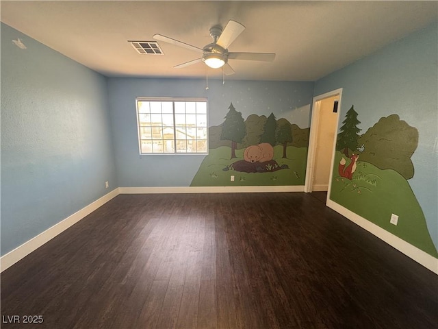 unfurnished room with visible vents, a ceiling fan, baseboards, and wood finished floors