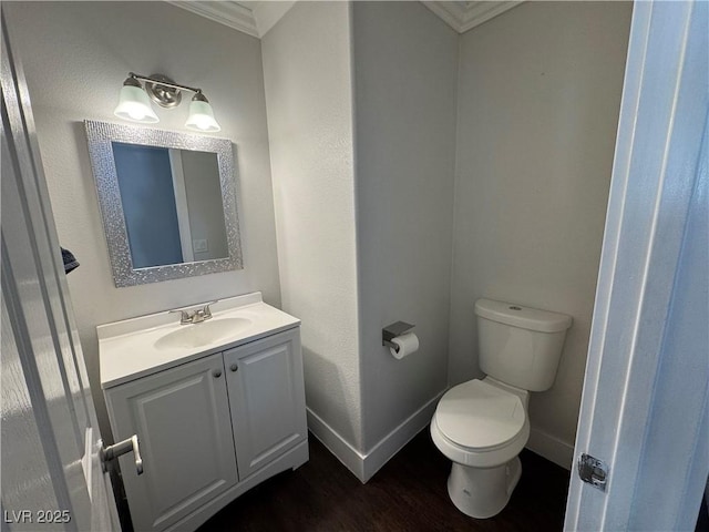 bathroom featuring ornamental molding, vanity, and wood finished floors