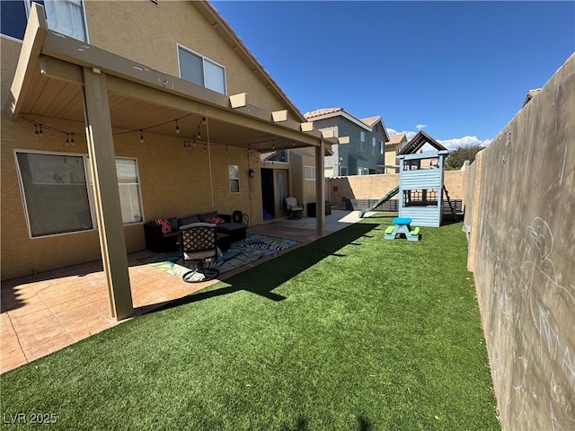 fenced backyard featuring a playground, a patio, and outdoor lounge area