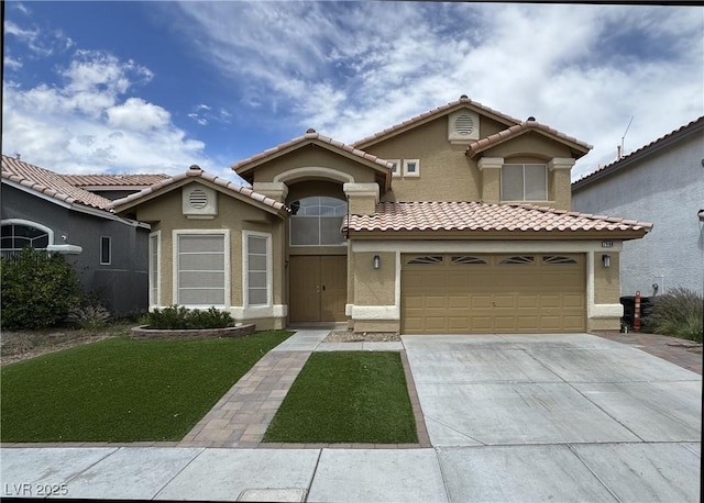 mediterranean / spanish home with a garage, a front yard, stucco siding, concrete driveway, and a tile roof
