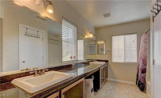 full bathroom with a sink, tile patterned flooring, double vanity, and visible vents