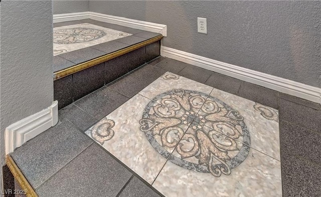 room details featuring baseboards and a textured wall