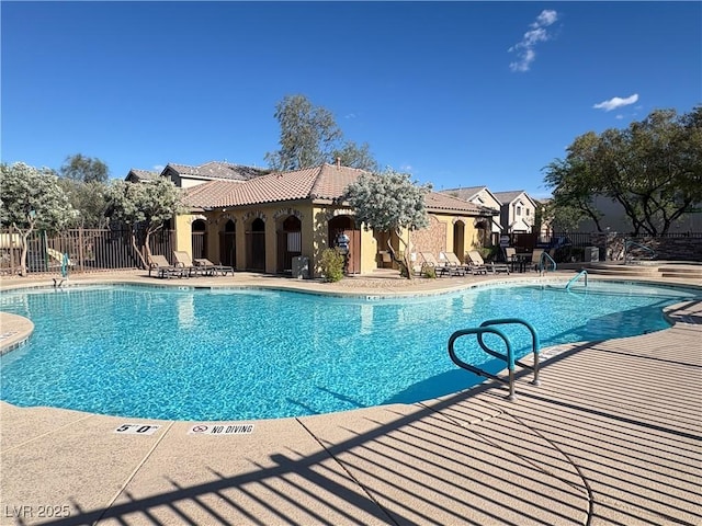pool with fence and a patio area