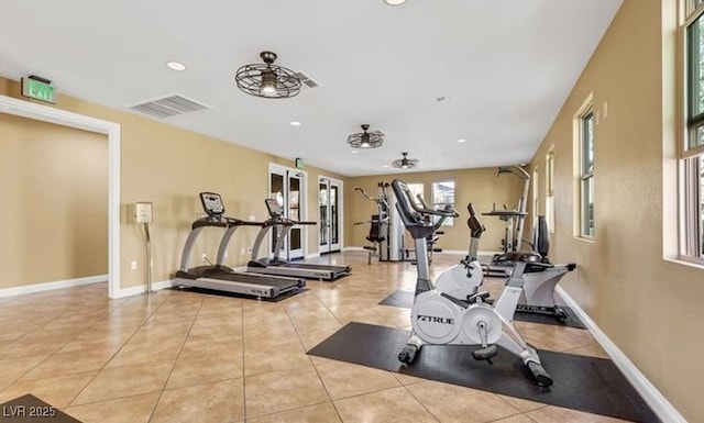 workout area featuring recessed lighting, baseboards, visible vents, and tile patterned floors