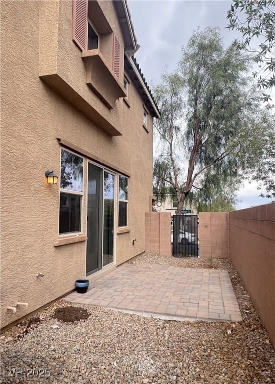 view of patio featuring a fenced backyard and a gate
