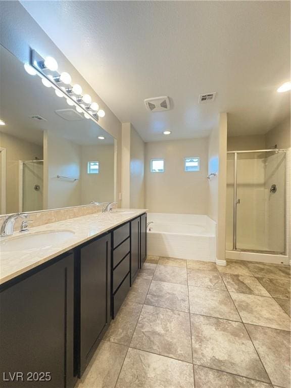 full bath featuring double vanity, visible vents, a shower stall, and a sink
