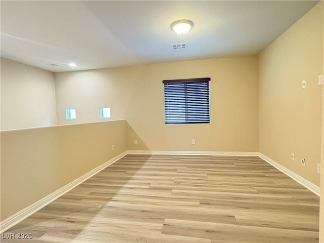 unfurnished room featuring baseboards, recessed lighting, wood finished floors, and visible vents