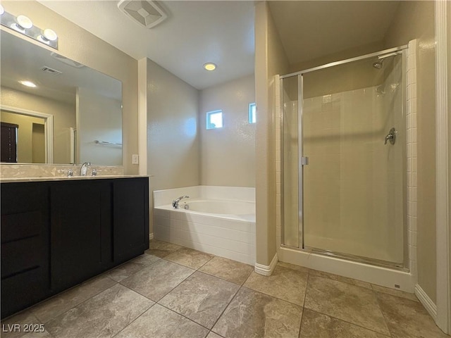 bathroom featuring vanity, visible vents, a bath, tile patterned floors, and a stall shower