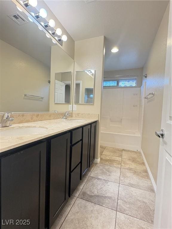 bathroom featuring double vanity, a sink, and bathing tub / shower combination