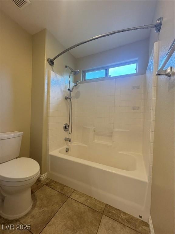 bathroom featuring toilet, tile patterned floors, baseboards, shower / washtub combination, and visible vents