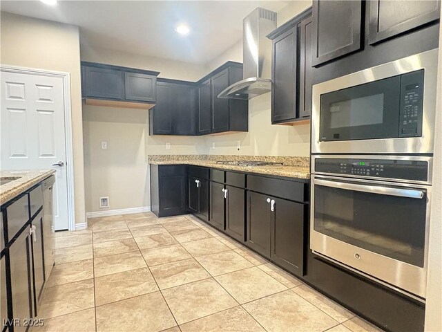 kitchen with light stone countertops, stainless steel appliances, recessed lighting, and wall chimney exhaust hood