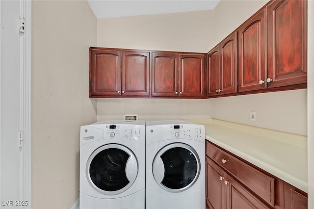 clothes washing area with cabinet space and washer and dryer