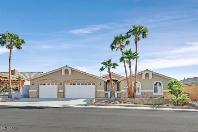 ranch-style home featuring stucco siding, driveway, stone siding, and a garage