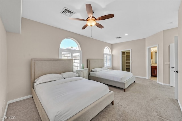 bedroom with baseboards, light colored carpet, and visible vents