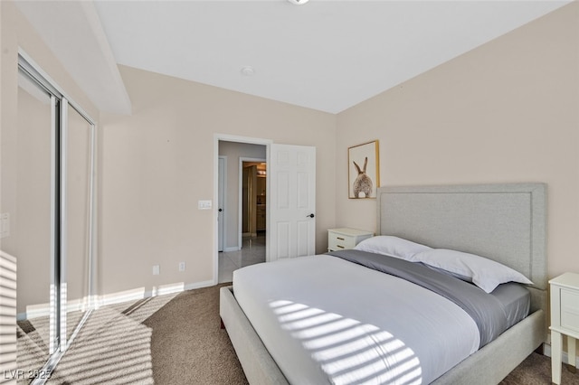 carpeted bedroom with baseboards and a closet