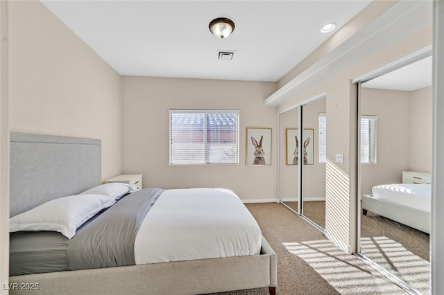 bedroom featuring baseboards, carpet flooring, and visible vents