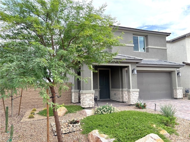 929 Hunter Shores Ave, North Las Vegas, NV 89084 - view of front of property featuring stucco siding, stone siding, a garage, and driveway