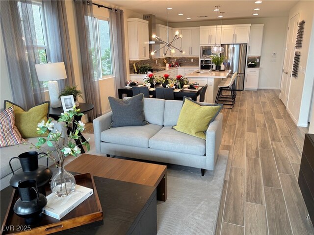 929 Hunter Shores Ave, North Las Vegas, NV 89084 - living area with light wood-style floors, a chandelier, and recessed lighting