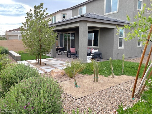 929 Hunter Shores Ave, North Las Vegas, NV 89084 - back of property featuring stucco siding, a patio area, and an outdoor living space