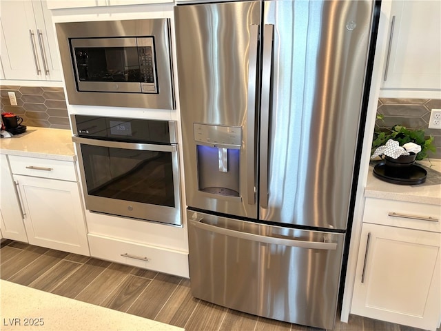 929 Hunter Shores Ave, North Las Vegas, NV 89084 - kitchen featuring stainless steel appliances, white cabinets, and tasteful backsplash