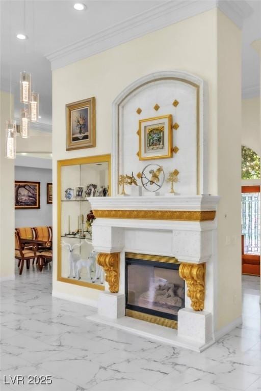 interior details with a glass covered fireplace, baseboards, ornamental molding, and recessed lighting