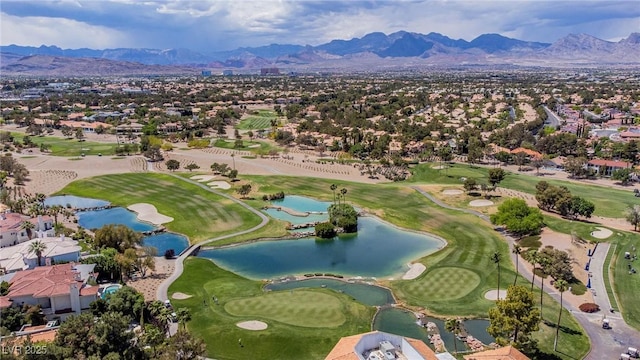 aerial view with a water and mountain view, view of golf course, and a residential view