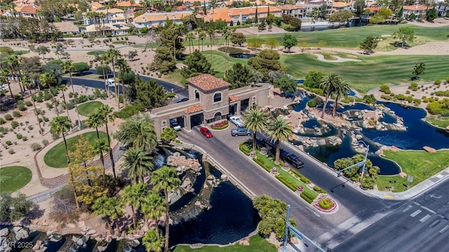 drone / aerial view with a water view and golf course view