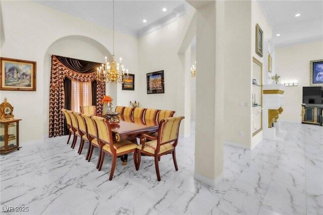 dining space featuring marble finish floor, ornamental molding, and a chandelier
