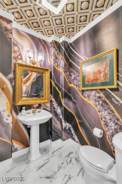 half bathroom featuring toilet and marble finish floor