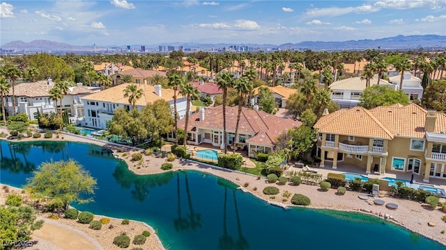bird's eye view with a water and mountain view and a residential view