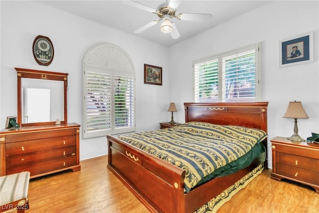 bedroom featuring baseboards, ceiling fan, and wood finished floors
