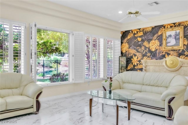 living area featuring a healthy amount of sunlight, marble finish floor, and visible vents
