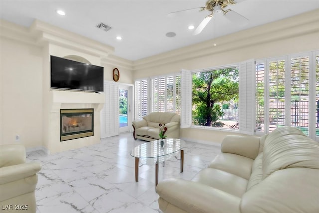 living area with visible vents, recessed lighting, marble finish floor, and a ceiling fan