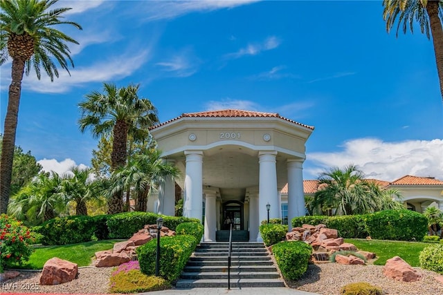 property entrance featuring stucco siding and a tiled roof