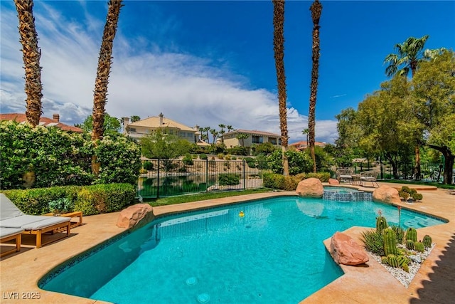 view of swimming pool featuring a pool with connected hot tub, fence, and a patio