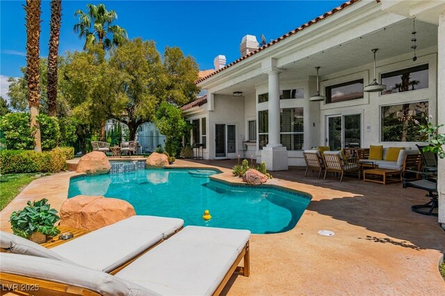 pool with a patio and an outdoor hangout area