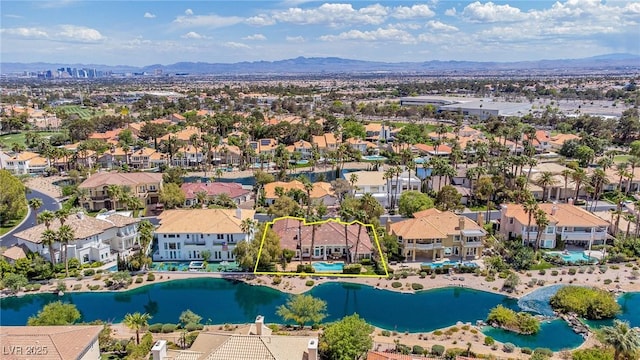 aerial view with a water and mountain view and a residential view