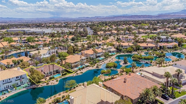 birds eye view of property featuring a water and mountain view and a residential view