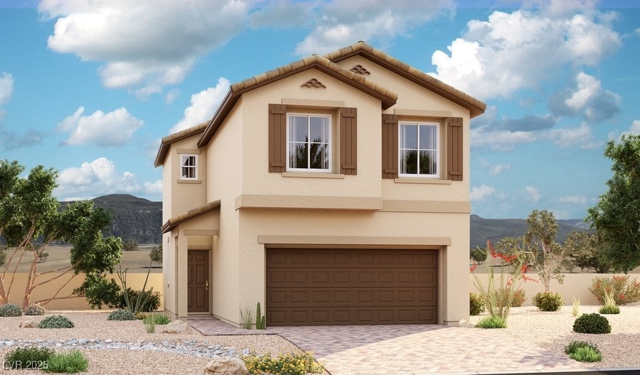 view of front of home featuring a mountain view, an attached garage, decorative driveway, and stucco siding