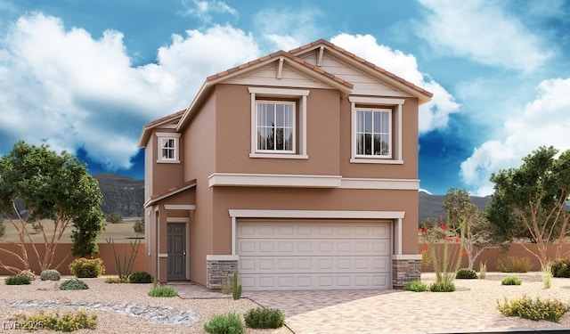 view of front of house featuring an attached garage, stucco siding, driveway, and fence